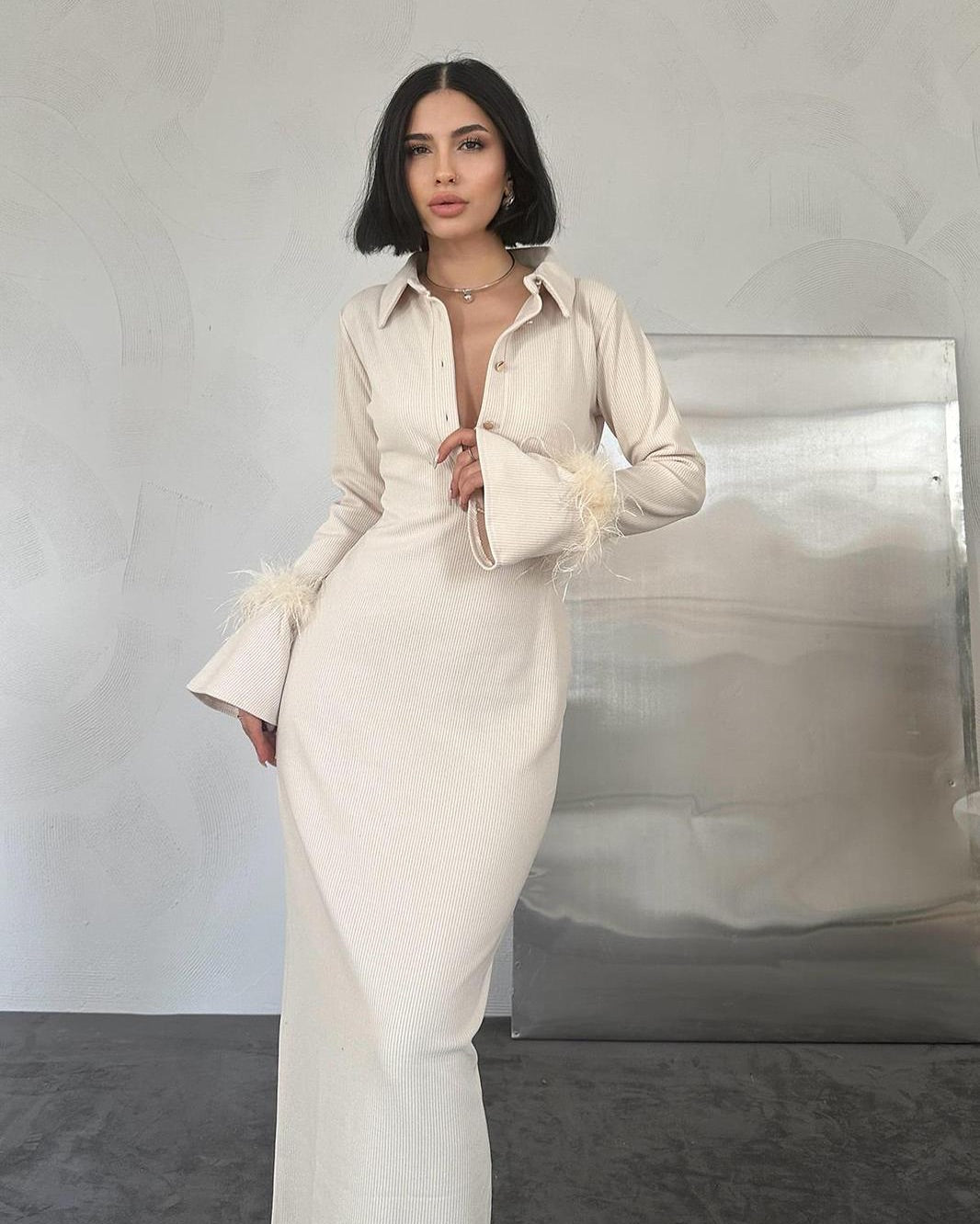 Beautiful beige dress with feather detailed sleeves